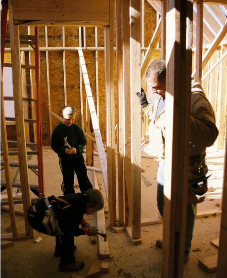 Nick as a child on a job site with his dad, building their first home